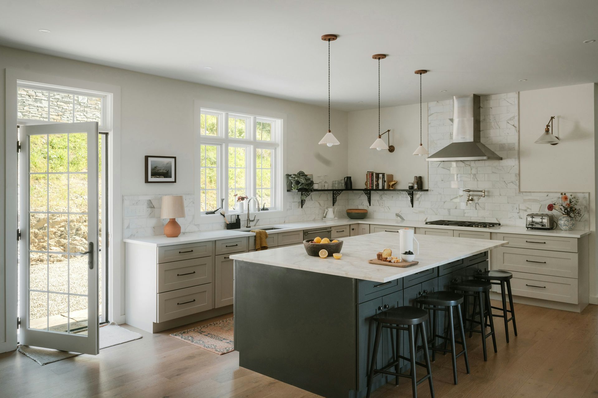 Modern kitchen with island and stainless steel appliances.
